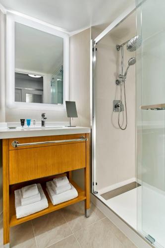 a bathroom with a sink and a shower at Delta Hotels by Marriott Richmond Downtown in Richmond