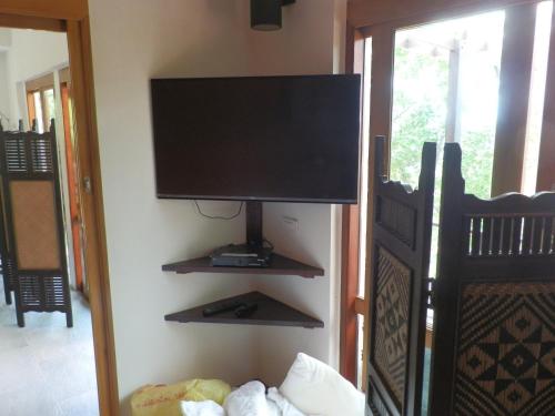 a flat screen tv on a wall in a room at Ocean View Mini-Villa in Wok Tum