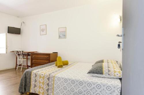 a bedroom with a bed and a dresser and a desk at Chambre Saint Pierre - Hypercentre in Gaillac