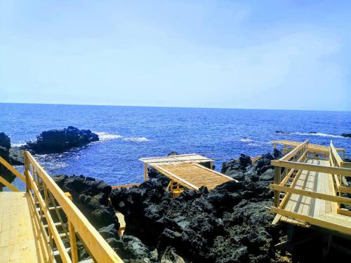 a house on the rocks near the ocean at La casa dei Capperi - The house of capers 1 in Acireale