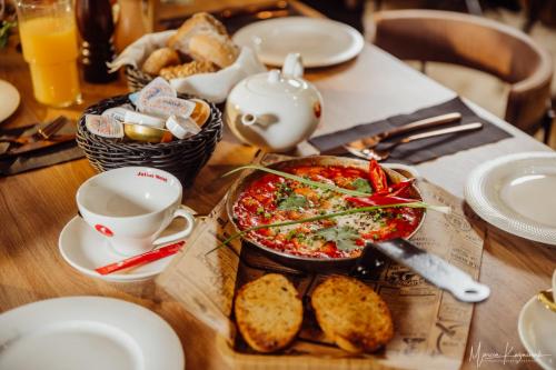 a table with a plate of food and a pizza at Cristal in Ustka