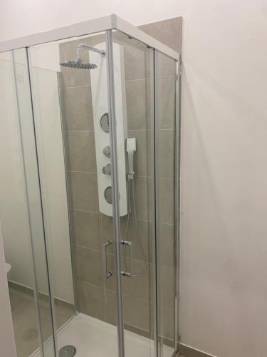 a shower with a glass door in a bathroom at Marilyn Home in Palermo