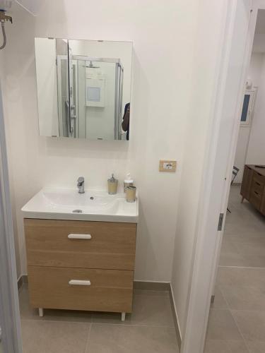 a bathroom with a sink and a mirror at Marilyn Home in Palermo