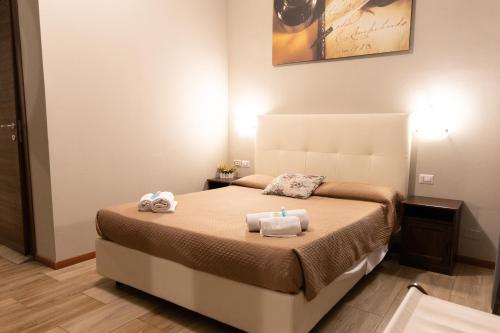 a bedroom with a bed with two towels on it at Golden Milano Hotel in Milan