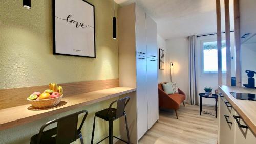 une cuisine avec un comptoir avec un bol de fruits dessus dans l'établissement - L'Horizon Bleu - Cocon romantique avec vue mer panoramique, à Gruissan