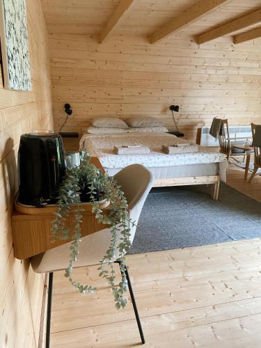 a bedroom with a bed and a desk with a tv at Taevaskoja Salamaa Camping in Taevaskoja