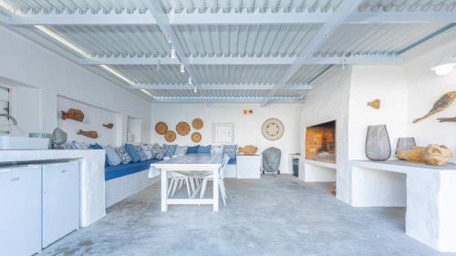 a living room with a table and a couch at Bliss on the Bay in Struisbaai