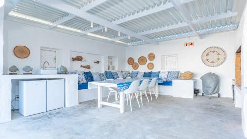 a white room with a table and chairs in it at Bliss on the Bay in Struisbaai