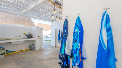 a room with surfboards hanging on a wall at Bliss on the Bay in Struisbaai