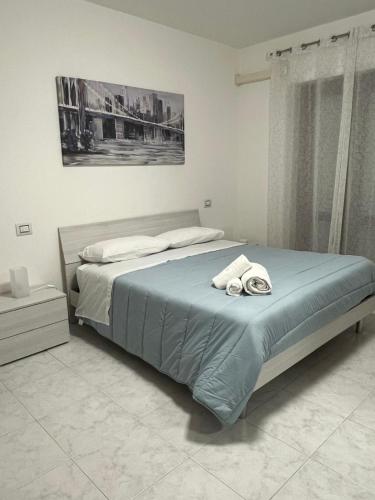 a bedroom with a bed with two towels on it at Casa di RO' in Taranto