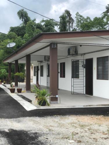 a small white building with a porch at Homestay Siti Klang in Klang