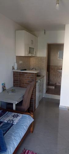 a kitchen with a table and a sink in a room at Perfect Place 2 - Djenovici in Ðenovići