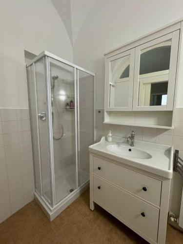 a white bathroom with a shower and a sink at Casa nel Vicolo - Duomo di Osimo e 20 min da Loreto in Osimo
