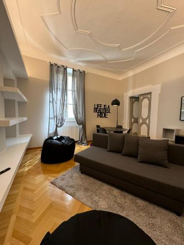 a living room with a couch and a table at Casa nel Vicolo - Duomo di Osimo e 20 min da Loreto in Osimo