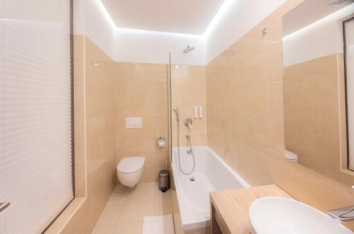 a bathroom with a shower and a toilet and a sink at Rooms Bella in Bled