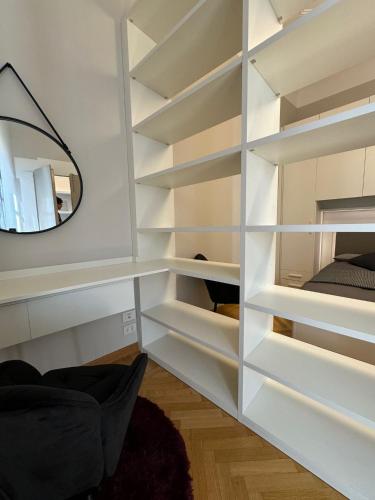 a room with white shelves and a mirror at Casa nel Vicolo - Duomo di Osimo e 20 min da Loreto in Osimo