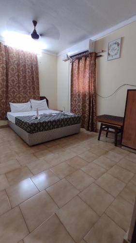 a bedroom with a bed in a room at Hotel YMCA - Near Meenakshi Amman Temple Madurai in Madurai