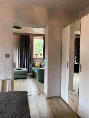 a living room with a couch and a mirror at Hotel & Restaurant Druidenstein in Trautenstein