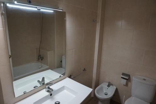 a bathroom with a sink and a toilet and a mirror at The BB Hotel Boutique Can Colom in Lloret de Mar