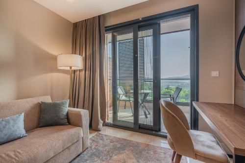 a living room with a couch and a table and a balcony at Montenegro Lodge in Tivat