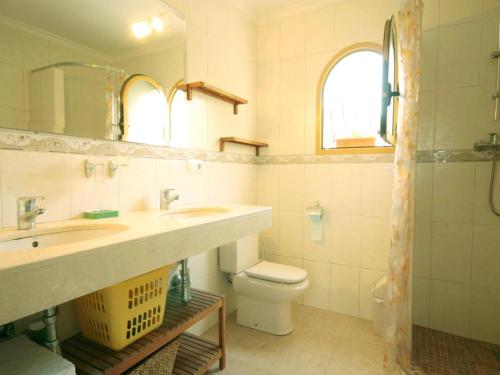 a bathroom with two sinks and a toilet at Villa Marycar in J&aacute;vea