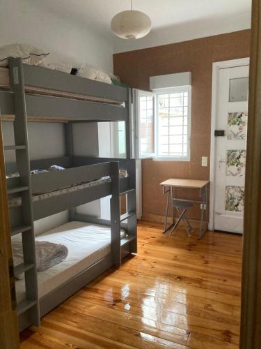 a bedroom with two bunk beds and a desk at Appartement à côté de la Gare in Hendaye
