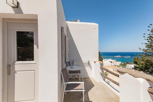 a balcony with a chair and a view of the ocean at Rania Apartments Sea View in Mýkonos City