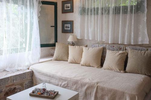 a living room with a couch and a table at Green and Blue View in Elliniká