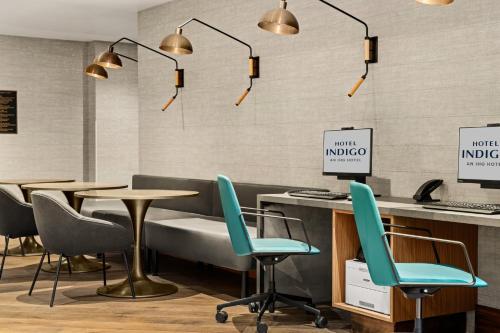 a restaurant with chairs and tables and lights at Hotel Indigo Vancouver Dwtn - Portland Area by IHG in Vancouver