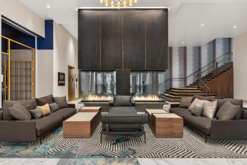 a living room with two couches and a fireplace at Hotel Indigo Vancouver Dwtn - Portland Area by IHG in Vancouver