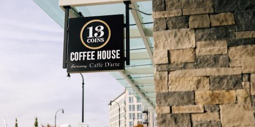 a coffee house sign hanging from the side of a building at Hotel Indigo Vancouver Dwtn - Portland Area by IHG in Vancouver