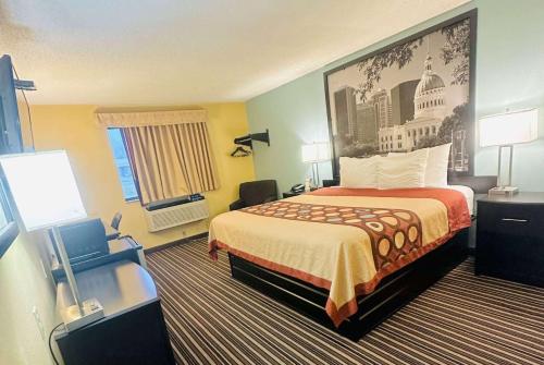 a hotel room with a bed and a large painting on the wall at Super 8 by Wyndham Warrenton in Warrenton
