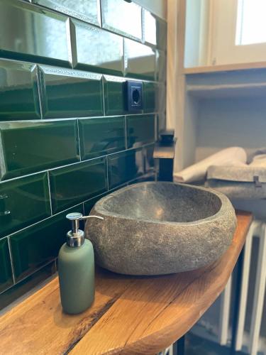 a bathroom sink with a soap dispenser on a counter at LIGHTQUARTIER Mountain Nest -Balkon in Sankt Andreasberg