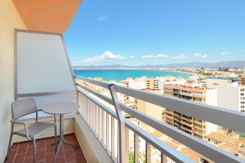 a balcony with a table and a view of the ocean at tent Bahia de Palma in El Arenal
