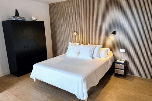 a bedroom with a bed with white sheets and pillows at Panoramic Design Loft in Las Palmas de Gran Canaria