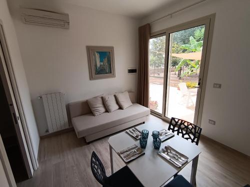 a living room with a couch and a table at LA CASA DEL NOCE in Ruffano