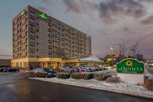 a hotel building with a sign in a parking lot at La Quinta by Wyndham New Haven in New Haven