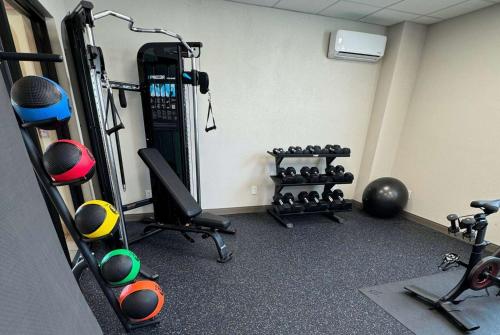 a room with a gym with tread machines and weights at La Quinta by Wyndham New Haven in New Haven