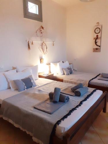 a room with two beds with towels on them at M. Houses 5 in Agios Romanos