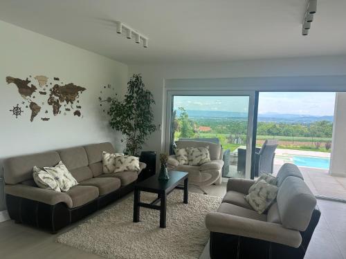 a living room with two couches and a table at Hacienda R - kuca sa bazenom in Siokovac