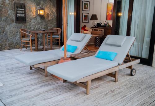 a couple of beds sitting in a living room at STORY Seychelles in Beau Vallon