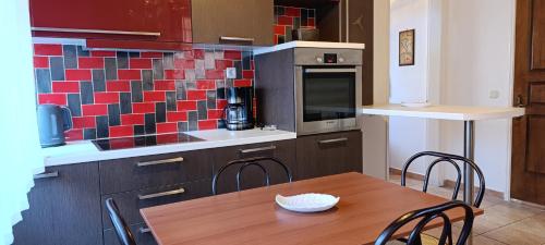 a kitchen with a wooden table with chairs and a counter at Traditional two level Apartment in Liapades