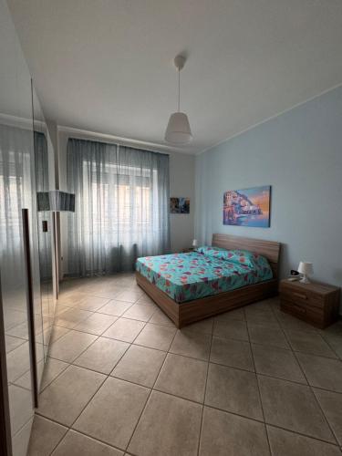 a bedroom with a bed and a lamp in it at Casa di Giulia un angolo della costiera Amalfitana in Salerno