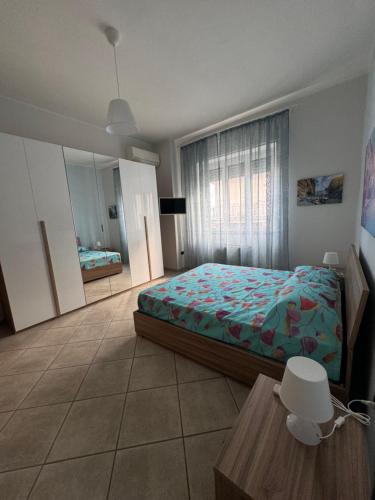 a bedroom with a bed and a large window at Casa di Giulia un angolo della costiera Amalfitana in Salerno