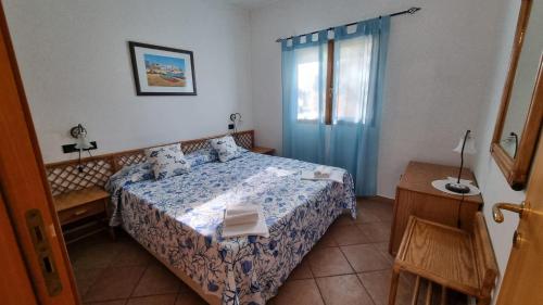 a small bedroom with a bed and a window at villetta pugnochiuso le macine vieste gargano in Vieste
