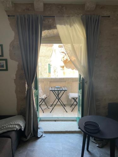 a room with a door open to a patio at Villa Roko in Jelsa
