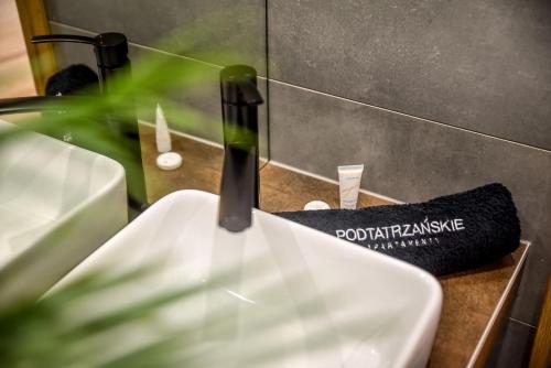 a close up of a toilet in a bathroom at Podtatrzańskie Apartamenty in Nowy Targ