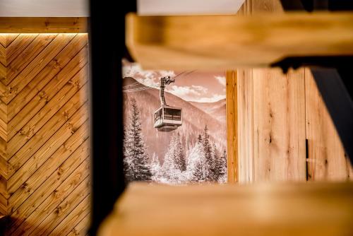 a ski lift with a picture of a mountain at Podtatrzańskie Apartamenty in Nowy Targ