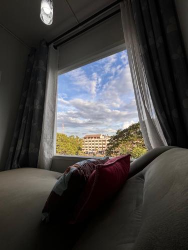 a window with a pillow in a bedroom with a view at Private room hosted by Boyce 401 in Chiang Mai
