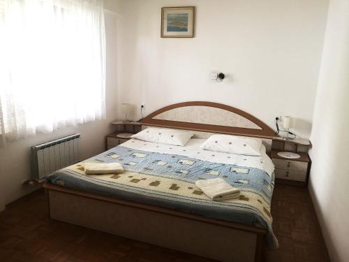 a bedroom with a bed with two towels on it at Apartma Vitez in Izola